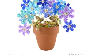 Un vaso di terracotta pieno di bellissimi fiori con perline facili, nei toni del blu, azzurro e viola.