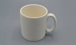 Tazza da dipingere, bianca e vuota, pronta per essere personalizzata con colori e fantasia.