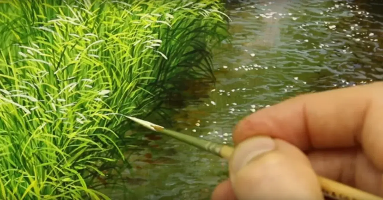 Un pennello finemente dipinge erba verde brillante e acqua scintillante, creando un paesaggio sereno.